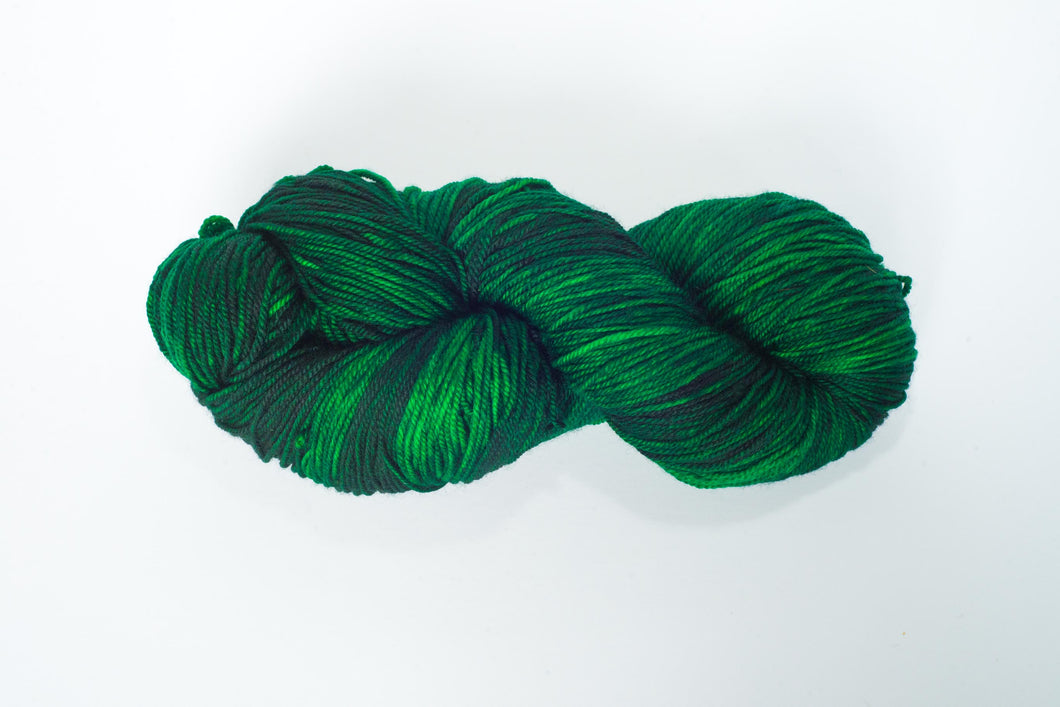 Hand Dyed Fingering Weight Superwash Merino cashmere nylon yarn in emerald green and black