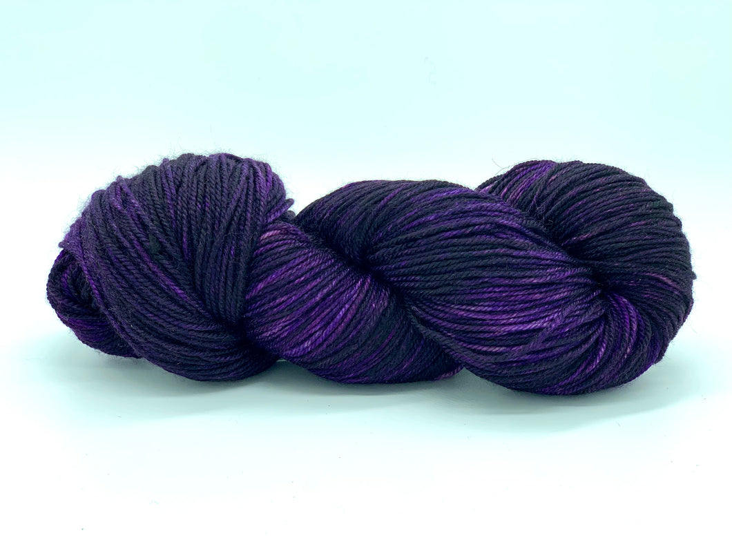 Hand Dyed Fingering Weight Superwash Merino cashmere nylon yarn in Deep purple and black