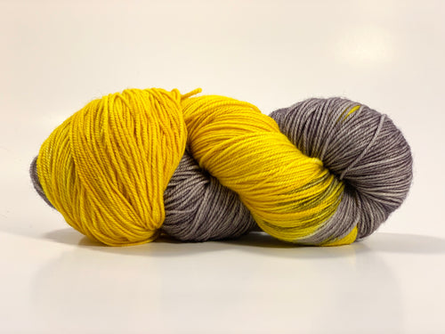 Hand Dyed Fingering Weight Superwash Merino cashmere nylon yarn in half bright yellow and half gray