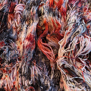 Hand Dyed Fingering Weight Superwash Merino cashmere nylon yarn in speckled red and black on white yarn