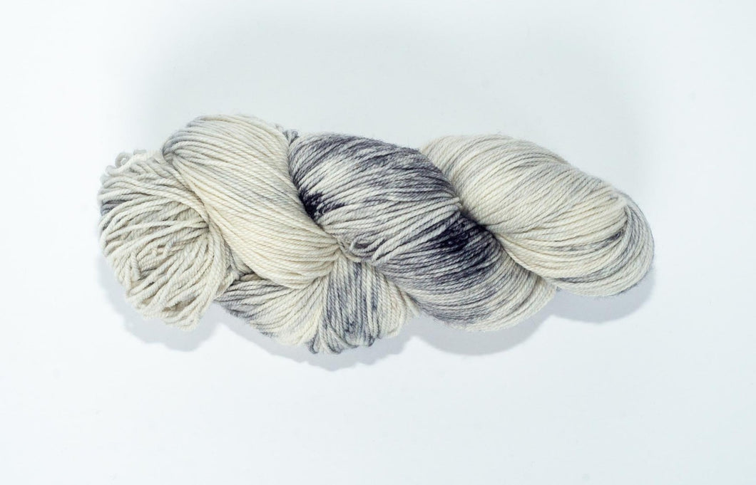 Hand Dyed Fingering Weight Superwash Merino cashmere nylon yarn in white with black and gray speckles
